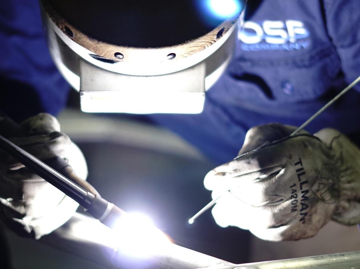 OSF welder TIG-welding stainless pipe in the dark during an emergency repair