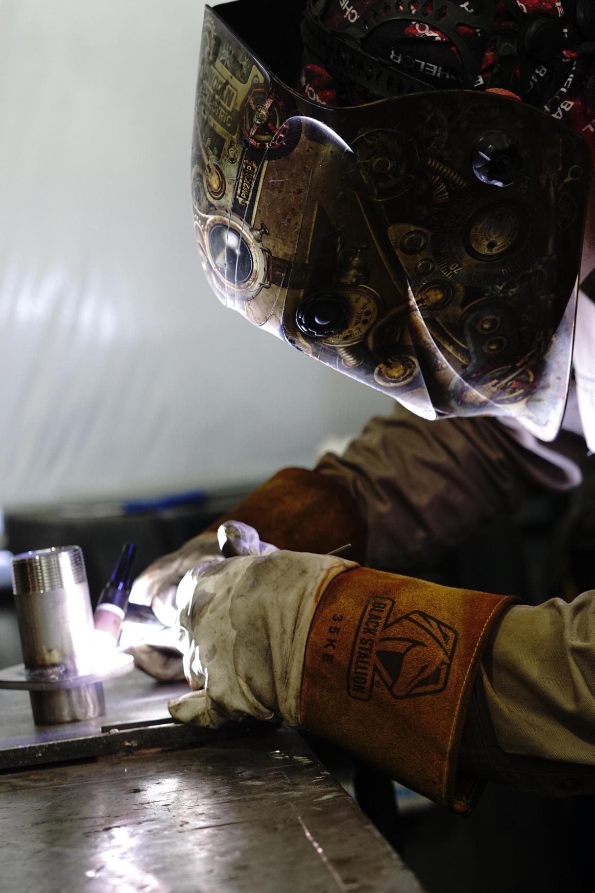 OSF welder TIG-welding a stainless fitting in the fabrication shop