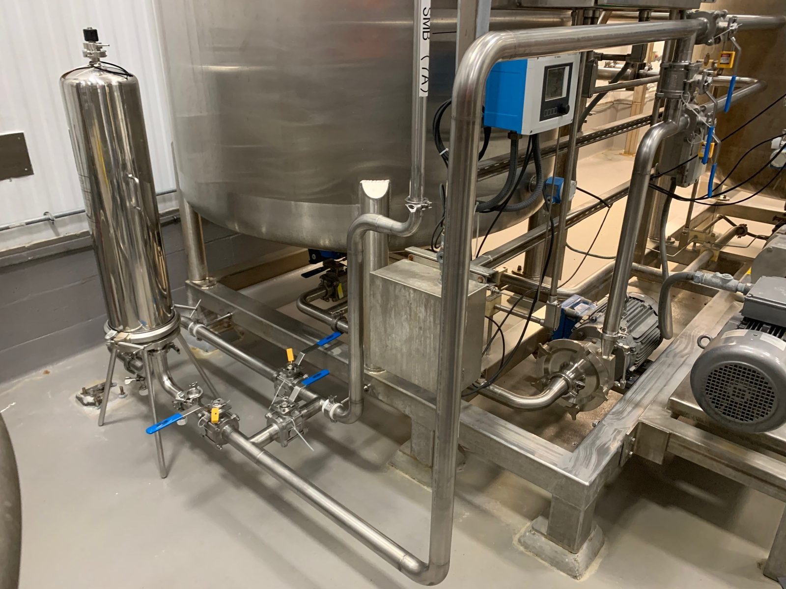 Dense sanitary process piping, valves, and pump on an OSF production-line install